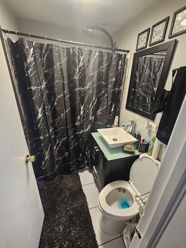 bathroom featuring a shower with curtain, vanity, tile patterned flooring, and toilet