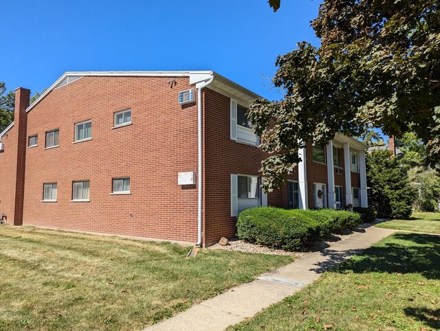 view of side of property featuring a yard