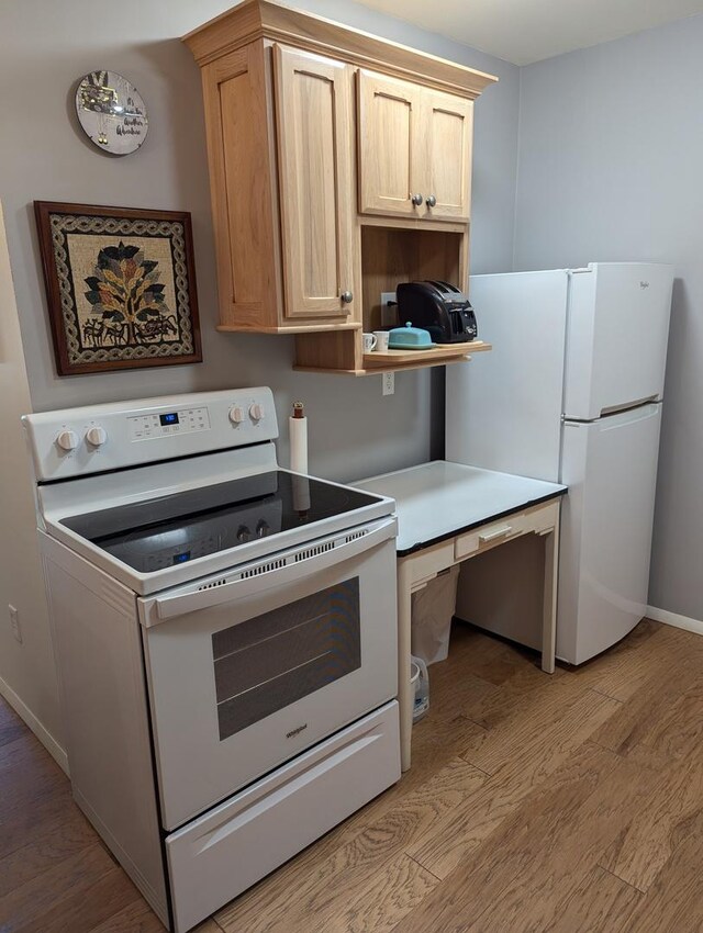 kitchen featuring light hardwood / wood-style flooring, white appliances, and light brown cabinets