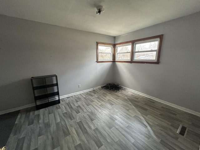 unfurnished room with hardwood / wood-style flooring