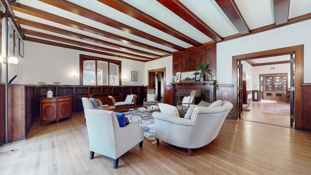 living room with beam ceiling and light hardwood / wood-style flooring