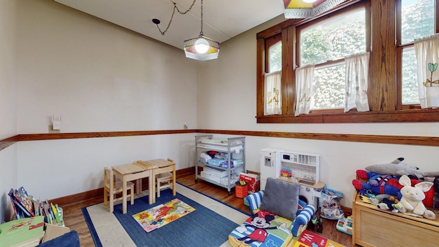 game room with dark hardwood / wood-style floors