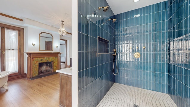 5235 S University Ave, Chicago, IL 60615 - full bath with a tile shower, wood finished floors, a tile fireplace, a bathtub, and recessed lighting