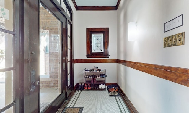 corridor with crown molding and tile patterned floors