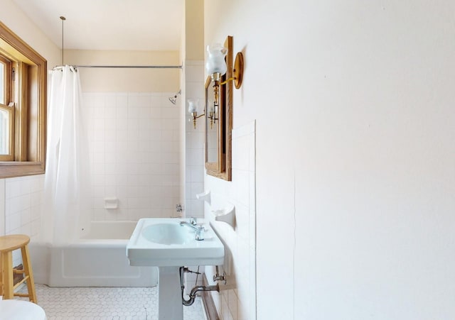 full bathroom with sink, tile walls, tile patterned flooring, shower / tub combo, and toilet