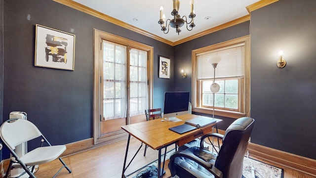 office space with a notable chandelier, a wealth of natural light, ornamental molding, and light hardwood / wood-style floors