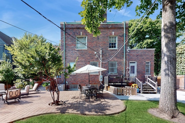 5235 S University Ave, Chicago, IL 60615 - rear view of property featuring a wooden deck, a patio, and brick siding