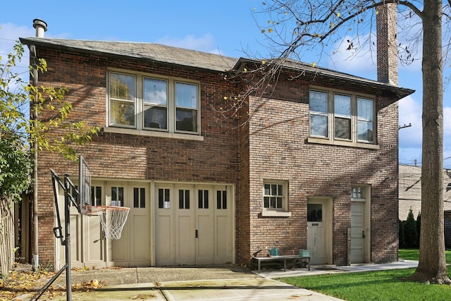 rear view of house with a garage