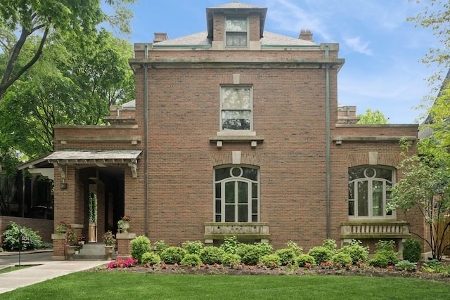5235 S University Ave, Chicago, IL 60615 - rear view of house featuring brick siding, a chimney, and a lawn