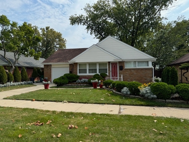 view of front of property with a garage and a front lawn