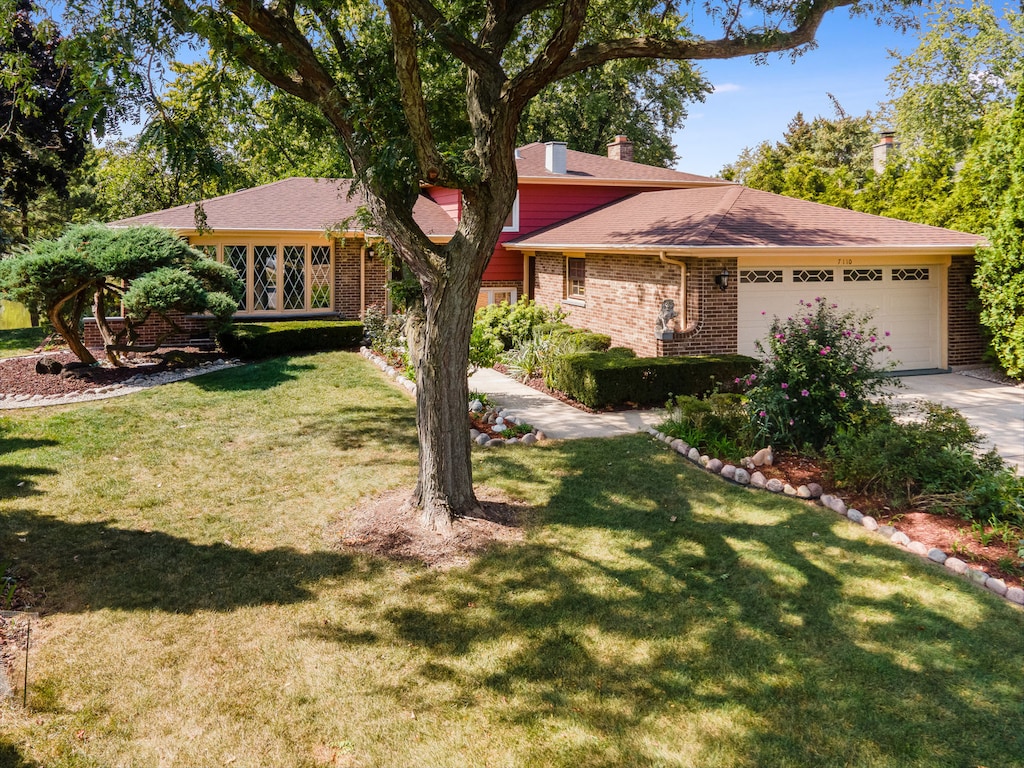 single story home featuring a front yard and a garage