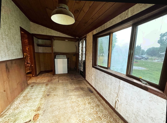 interior space with wooden ceiling, lofted ceiling, and washer / dryer