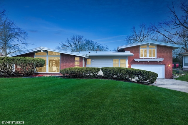 view of front of property with a lawn and a garage