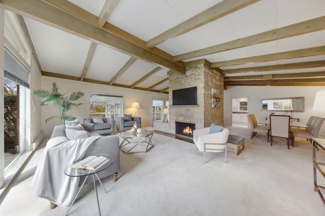 living room with carpet floors, a fireplace, lofted ceiling with beams, and a wealth of natural light