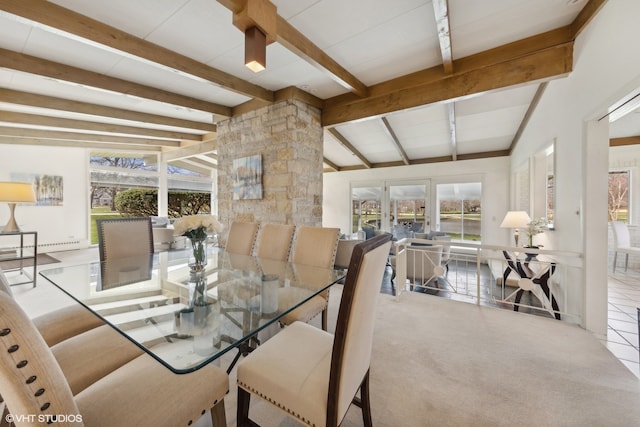 tiled dining room featuring lofted ceiling with beams and a wealth of natural light