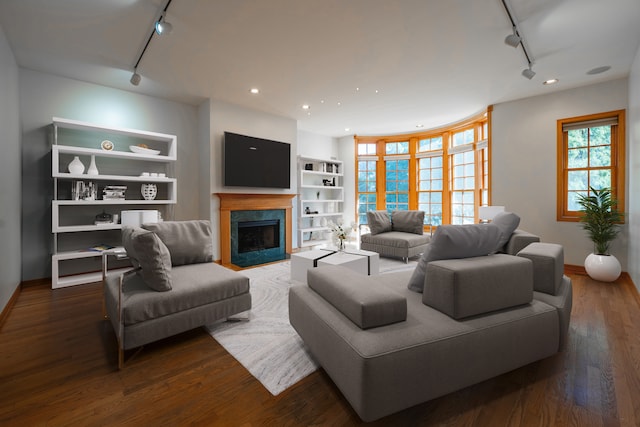 unfurnished living room with light hardwood / wood-style floors, a fireplace, and track lighting