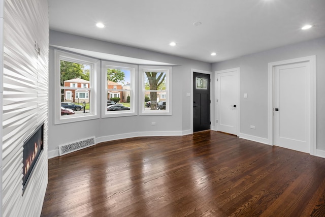 unfurnished living room with dark hardwood / wood-style floors