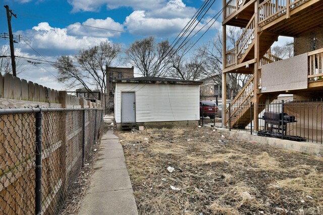 view of yard with an outdoor structure and a fenced backyard