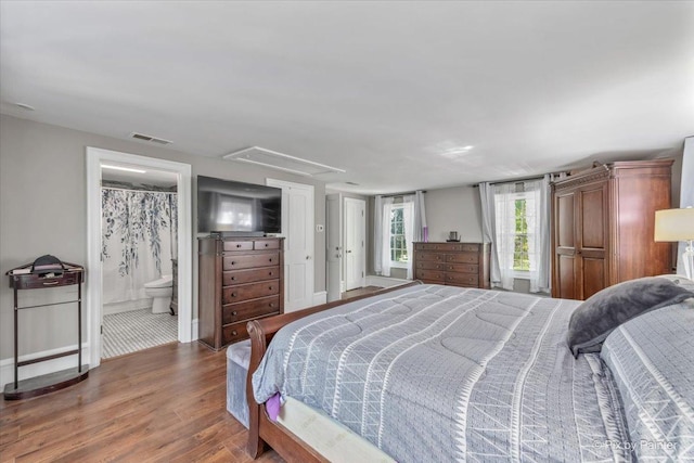 bedroom featuring hardwood / wood-style floors and connected bathroom