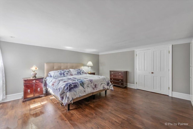 bedroom with a closet and dark wood-type flooring