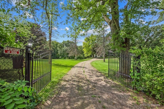 view of gate with a yard