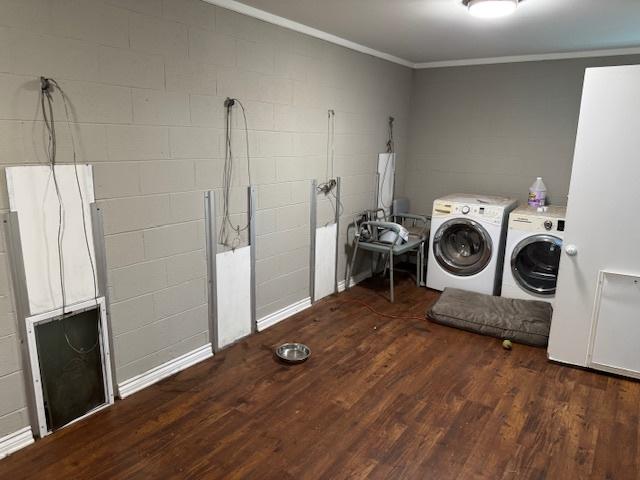 washroom with separate washer and dryer, dark hardwood / wood-style flooring, and crown molding