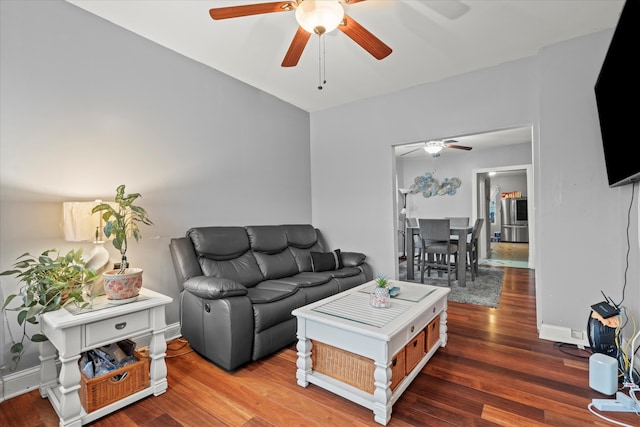 living room with ceiling fan and dark hardwood / wood-style flooring