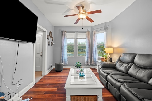 living room featuring dark hardwood / wood-style flooring and ceiling fan