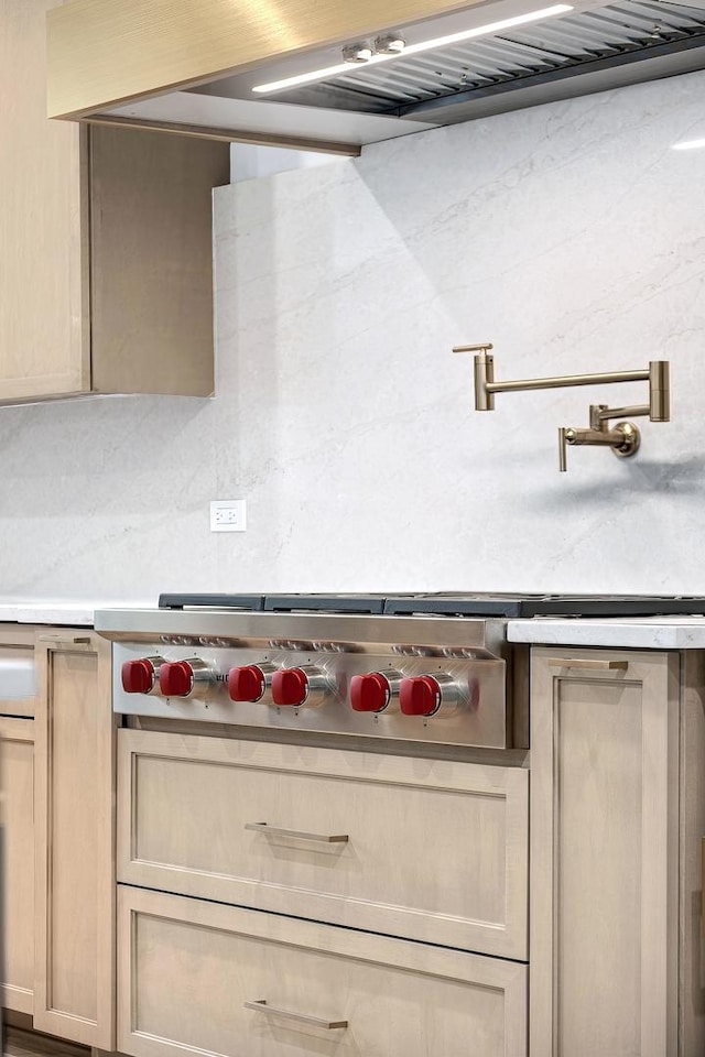 room details featuring tasteful backsplash and stainless steel gas cooktop