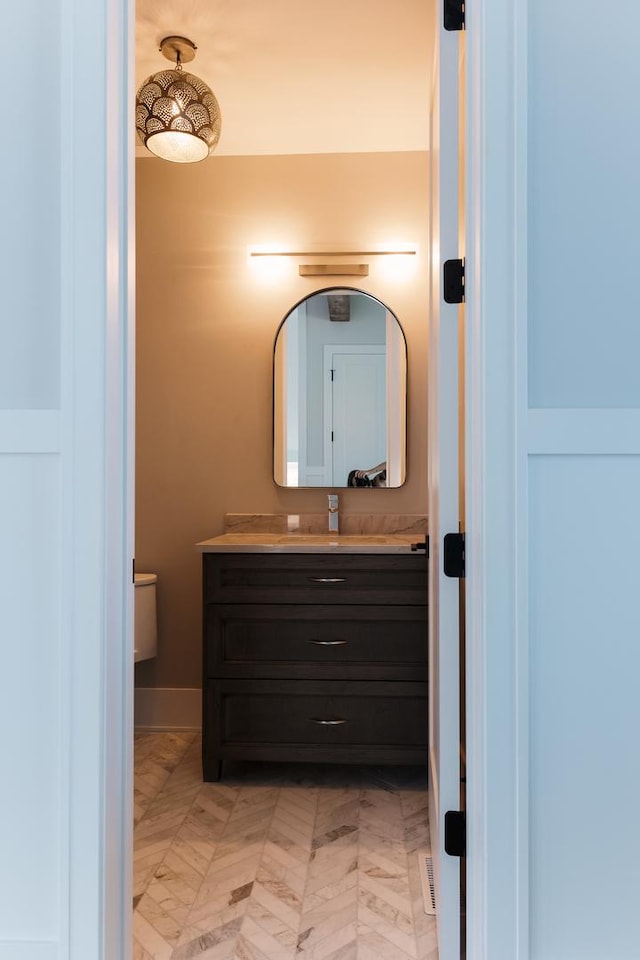 bathroom featuring vanity and toilet