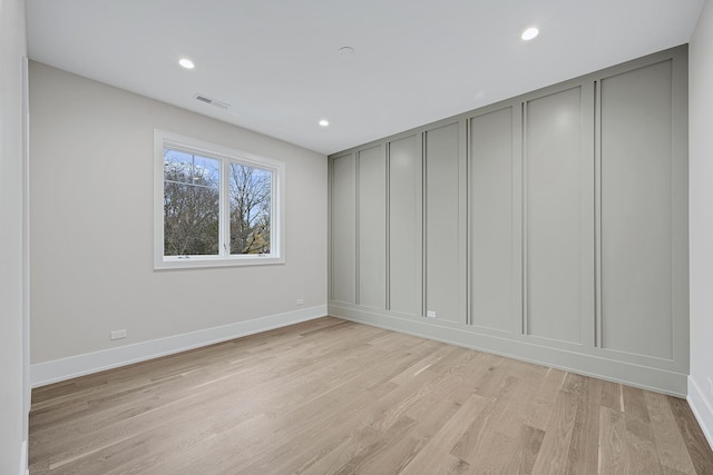 spare room with light hardwood / wood-style flooring