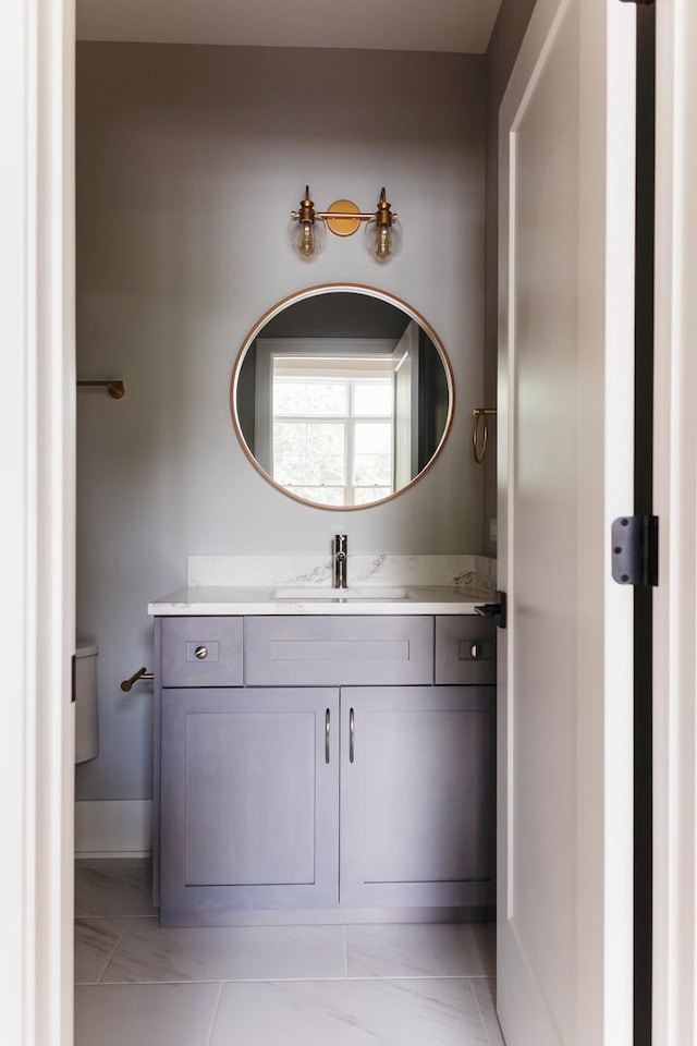 bathroom featuring vanity and toilet