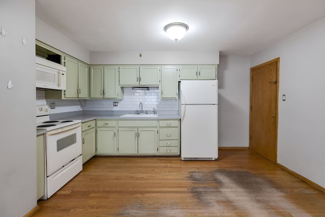 kitchen featuring green cabinets, light hardwood / wood-style flooring, sink, and white appliances