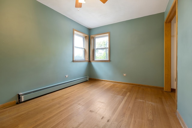 empty room with light hardwood / wood-style floors, baseboard heating, and ceiling fan