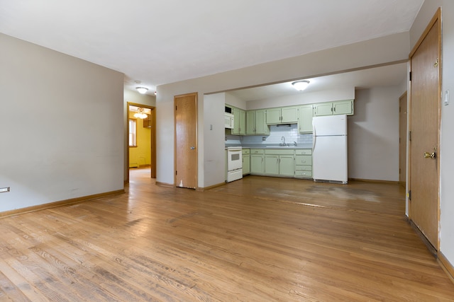 unfurnished living room featuring light wood-type flooring and sink