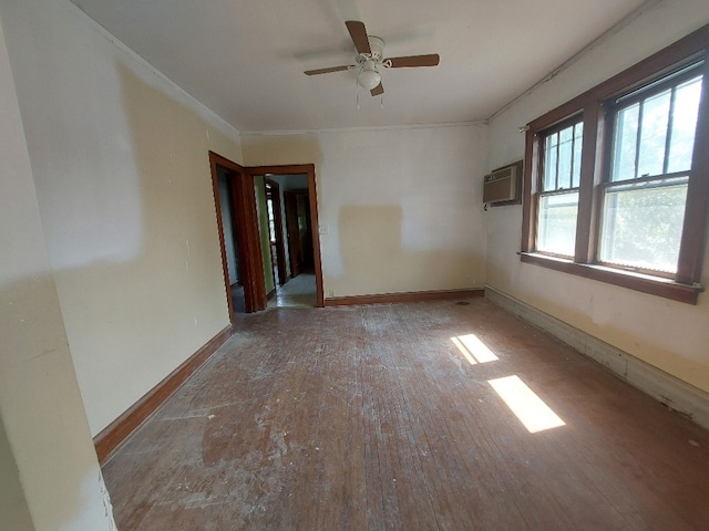 spare room with wood-type flooring, a wall unit AC, ceiling fan, and crown molding