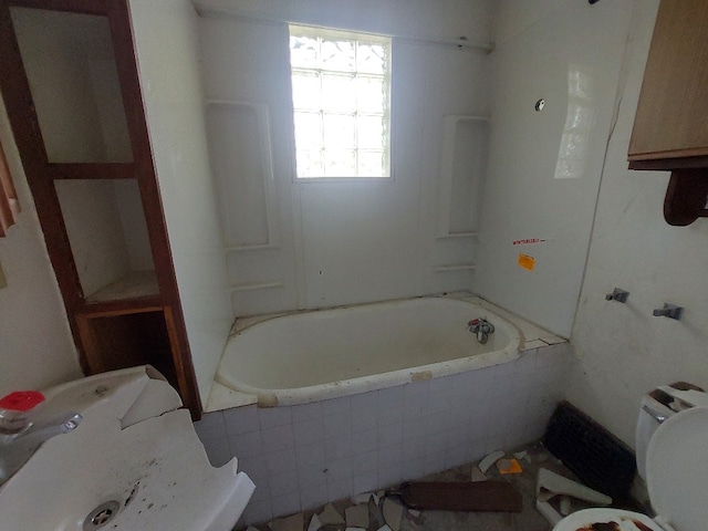 bathroom with tiled bath and toilet