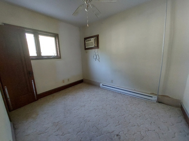 carpeted empty room with ceiling fan, a baseboard radiator, and a wall unit AC