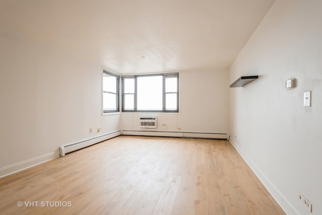 unfurnished room with a wall mounted air conditioner and light hardwood / wood-style floors