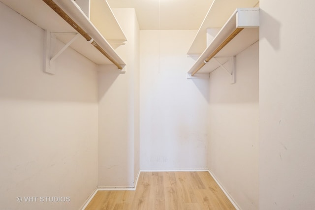 walk in closet featuring light hardwood / wood-style flooring