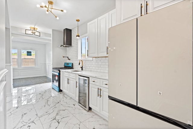 kitchen with range with gas cooktop, wine cooler, white refrigerator, white cabinets, and wall chimney range hood