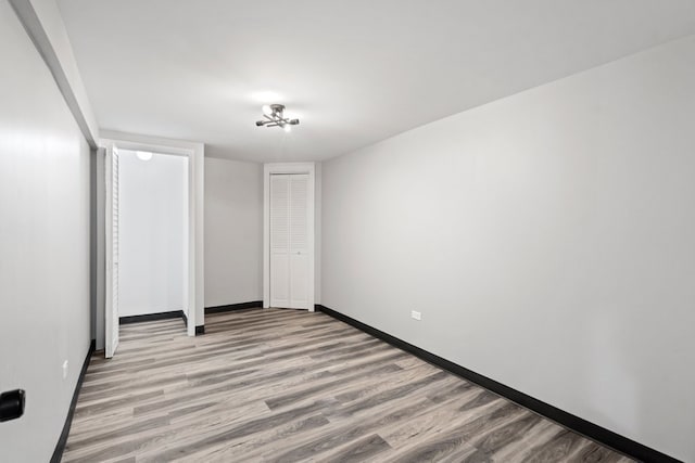 unfurnished bedroom featuring light wood-type flooring and a closet