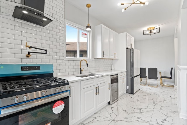 kitchen featuring white cabinetry, light stone counters, stainless steel appliances, sink, and wall chimney range hood