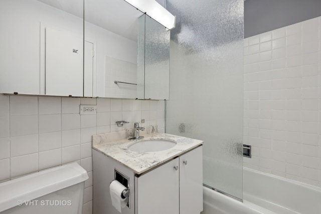 full bathroom with toilet, tile walls, decorative backsplash, shower / bathtub combination, and vanity