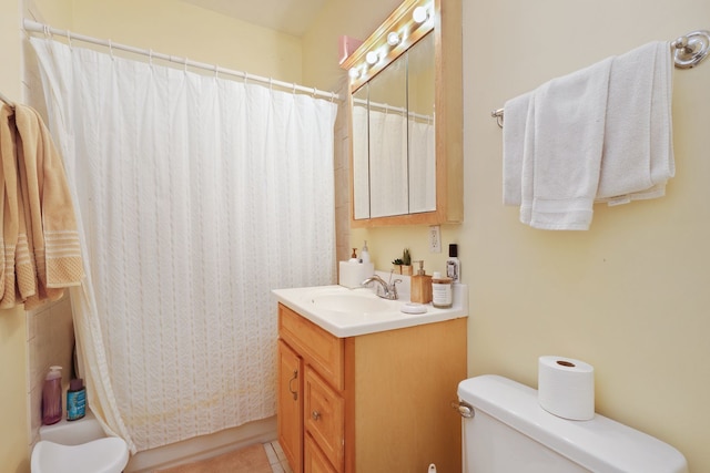 bathroom with a shower with curtain, vanity, toilet, and tile patterned floors