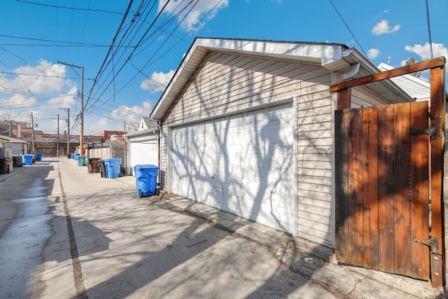 view of property exterior featuring a garage and an outbuilding