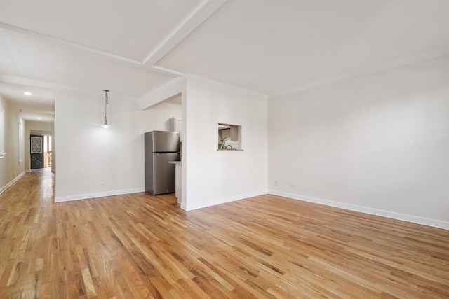 unfurnished living room featuring ornamental molding and light hardwood / wood-style floors