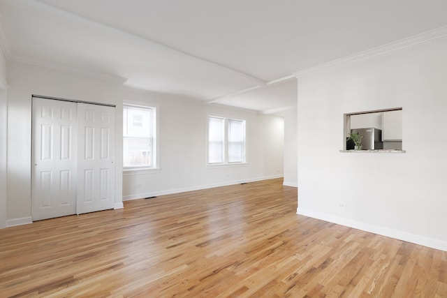 unfurnished living room featuring light hardwood / wood-style flooring and crown molding