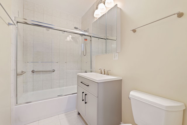 full bathroom featuring vanity, tile patterned flooring, toilet, and combined bath / shower with glass door