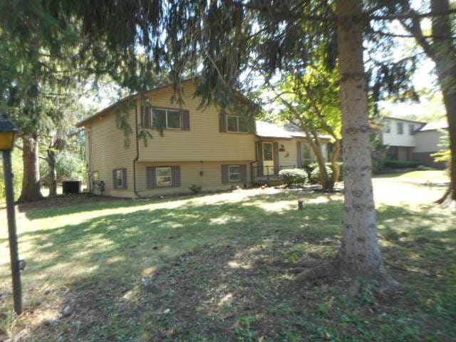 rear view of property featuring a yard